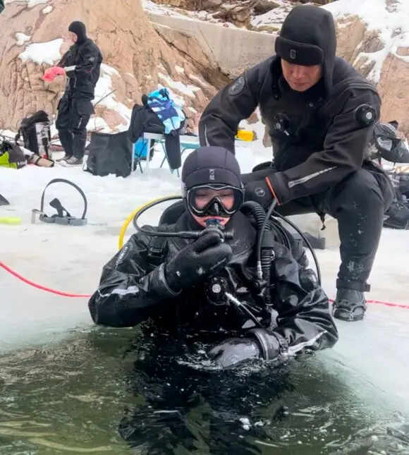 Ice diving student entering through the ice hole, Hongcheon River