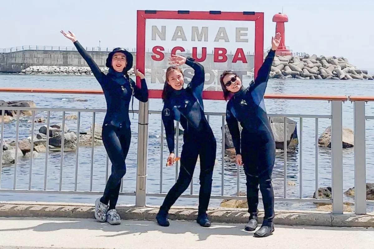 Group of NB Divers members in wetsuits smiling together at Namae Scuba Resort on Korea&rsquo;s East Sea coast