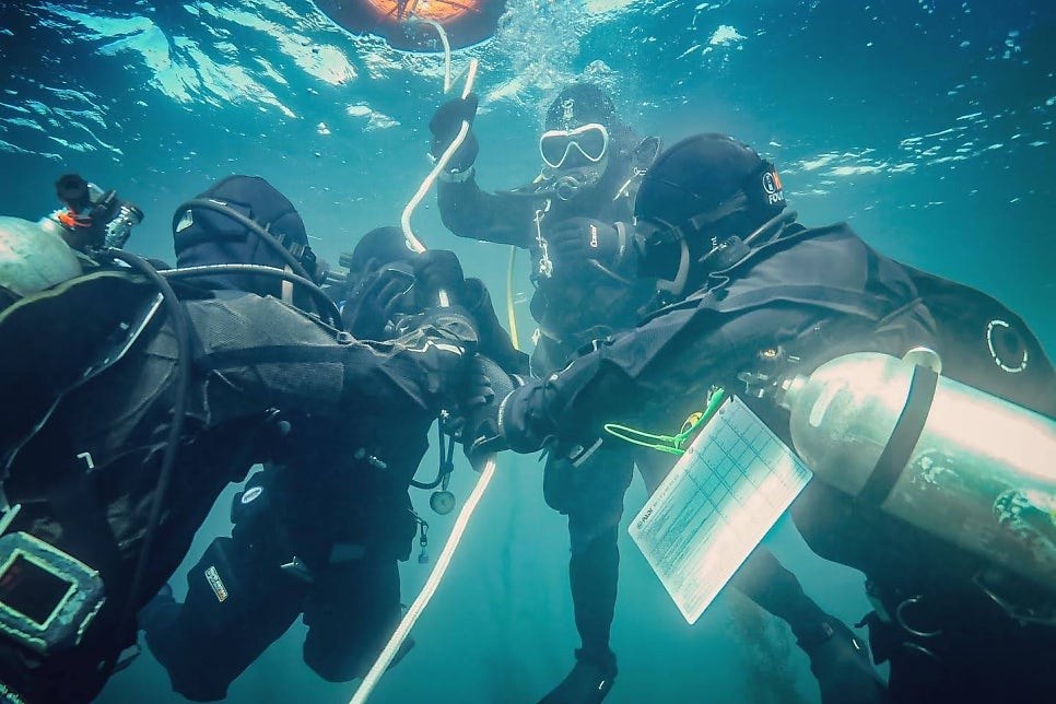 PADI IDC candidates training underwater with slates in Seoul - NB Divers